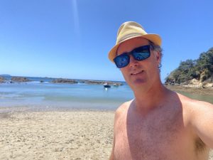 Man relaking on sunny waiheke beach